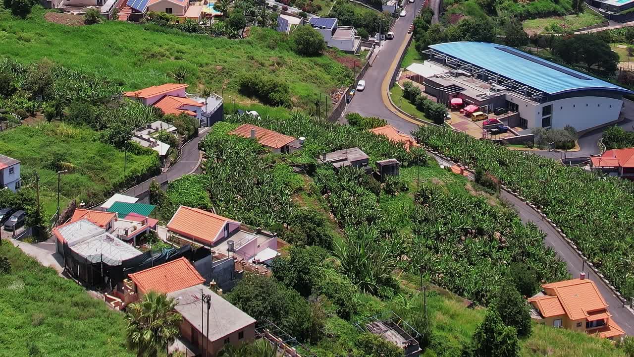 Drone view of lush landscape and homes in Madeira, Portugal