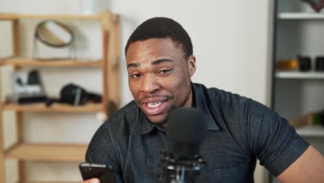 pleasant smiling black man communicates by voice online