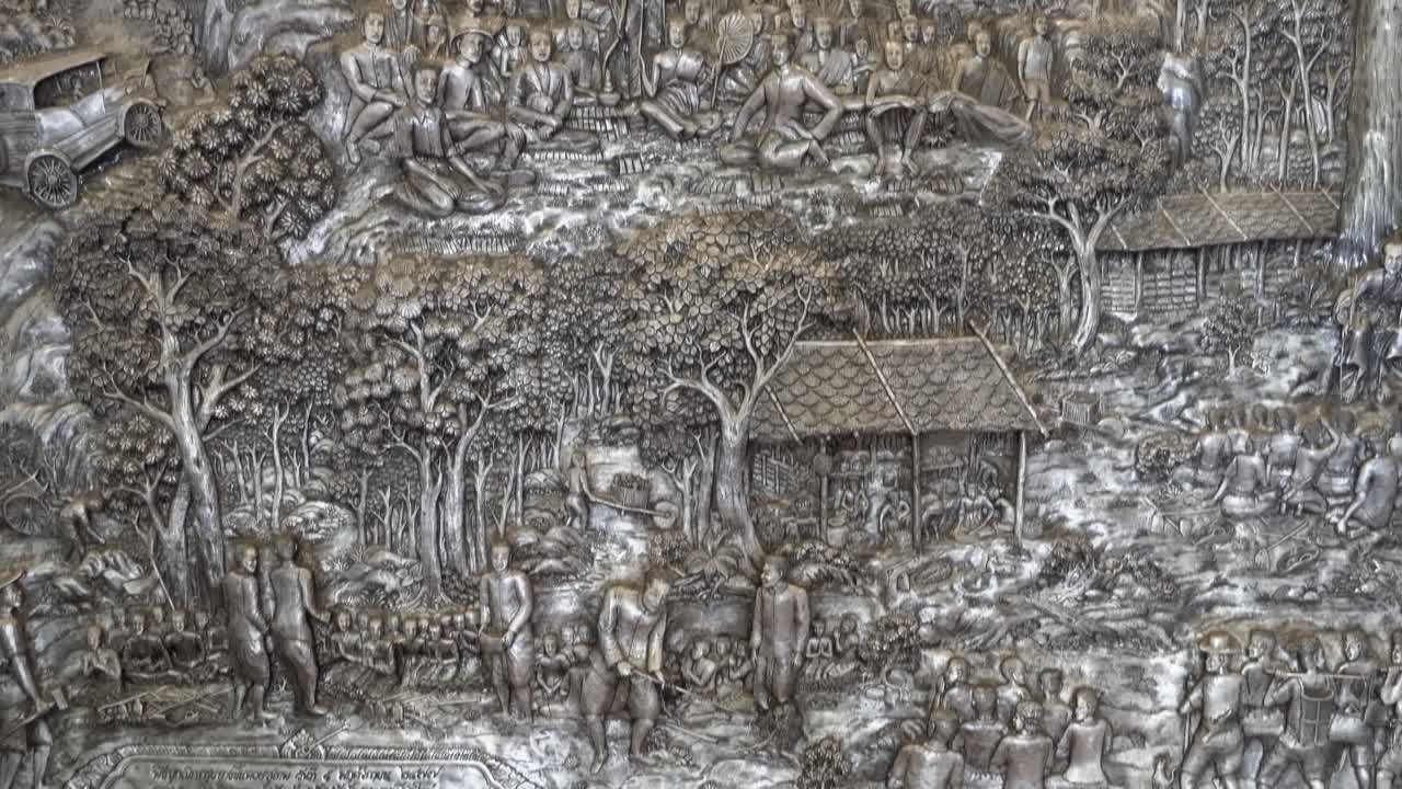 Thailand,Chiang Mai,Tilt up slowly over the amazing silver reliefs at the Famous Silver Temple,Wat Si Supan. Amazing silversmithing art.