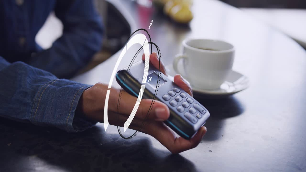 Merchant tilting POS while buyer tapping card, HUD rotating over POS authorizing finance payment