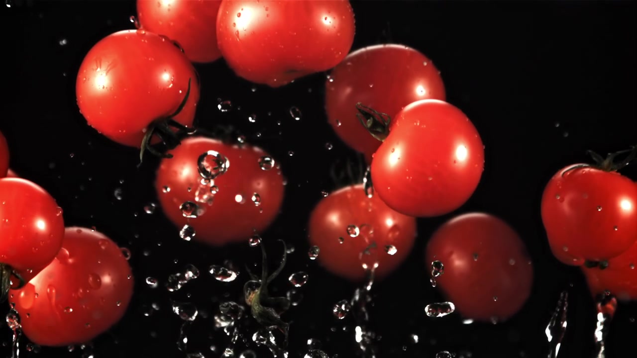 Slow Motion of Red Cherry Tomatoes Falling with Water Drops