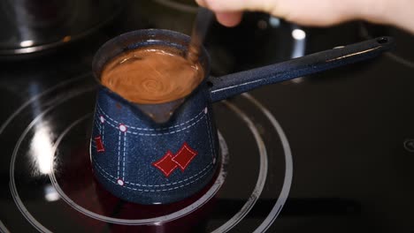 preparar café turco en casa, primer plano, nadie, mano masculina revolviendo café con una cuchara