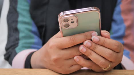 woman holding smartphone in cafe