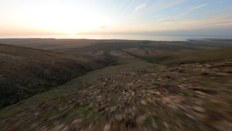 fuerteventura-east-coast-fpv-mountain-dive-during-sunset-beautiful-smooth-mountain-landscape