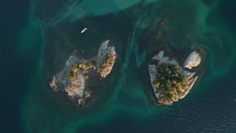 aerial - sailboat next to two islands on correntoso lake, neuquen, argentina