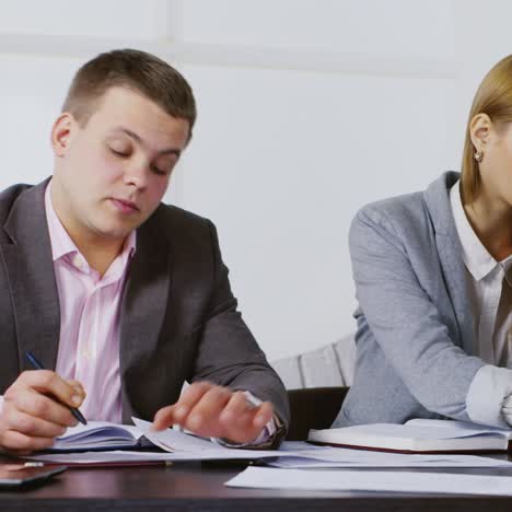 discussion between a young businessman and colleague 01