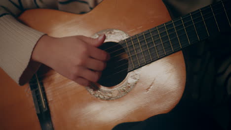 woman playing guitar writing song composing music