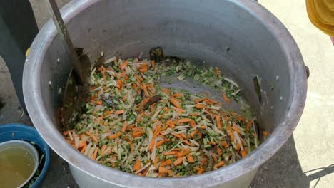 cooking vegetables in a large aluminium pot