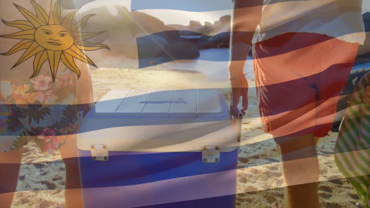 Uruguay flag animation over people carrying cooler on sunny beach