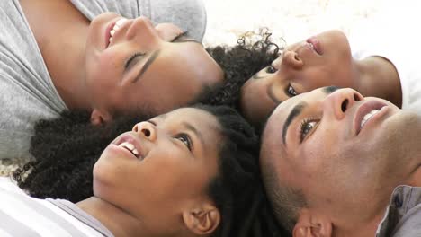 afroamerican family on floor with heads together