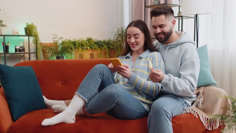 family man woman using credit bank card and smartphone transferring money purchases online shopping