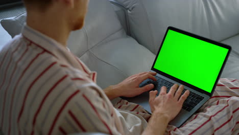 Freelancer-browsing-web-green-laptop-screen-closeup.-Man-shopping-online-weekend