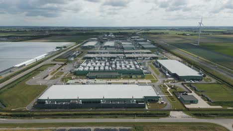 expansive drone shot showing the full scale of a data center complex at eemshaven, used for cloud platforms, big data processing, and ai infrastructure