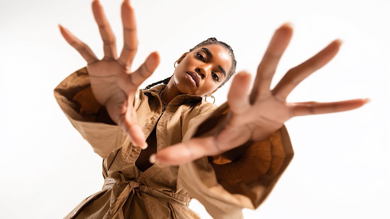 Young model posing showing hands in slow motion on white background