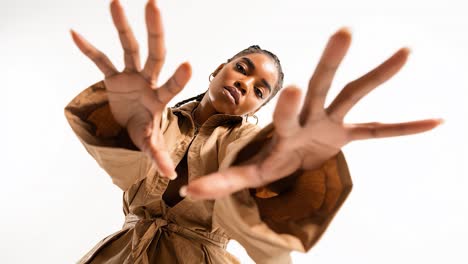 young model posing showing hands in slow motion on white background