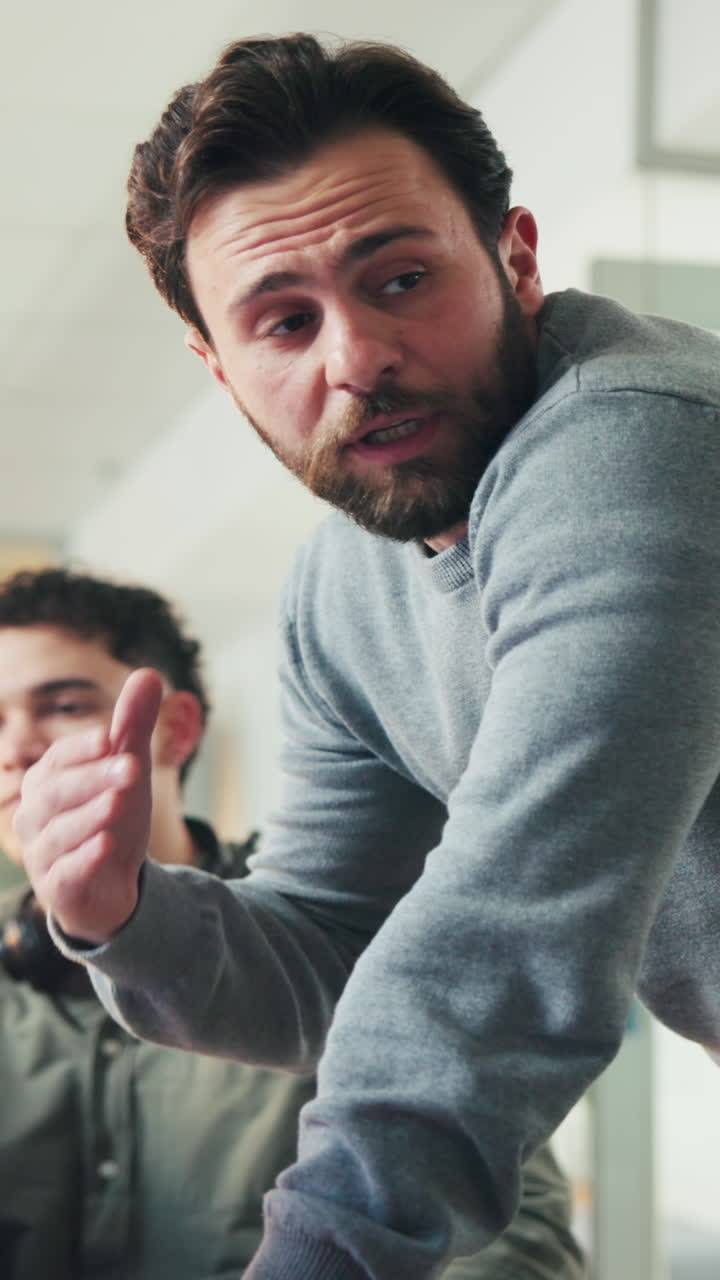 Bearded Man Discussing and Gesturing in an Office Setting
