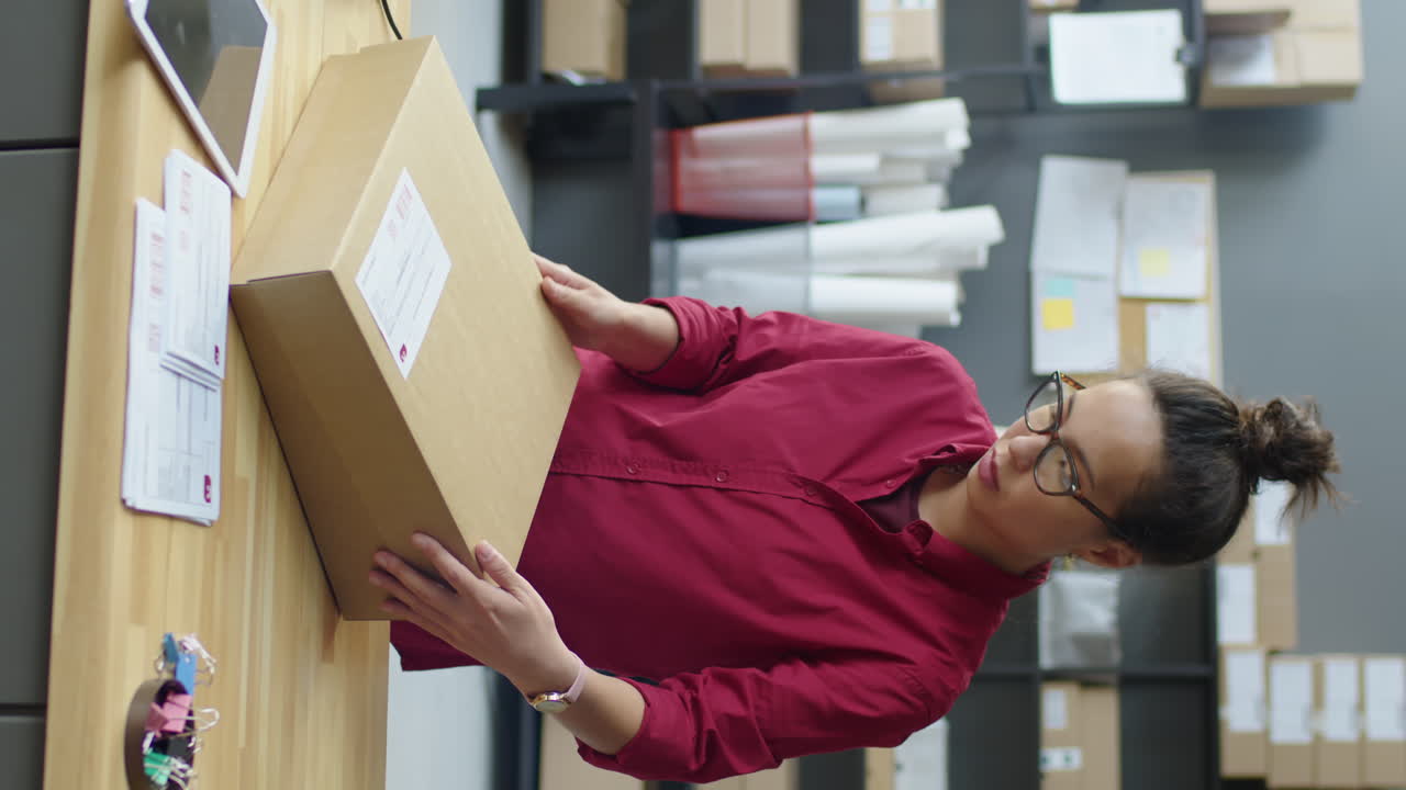 Female Delivery Service Worker Packing Parcel