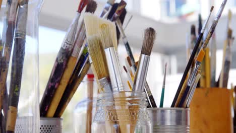 various paintbrush in glass container