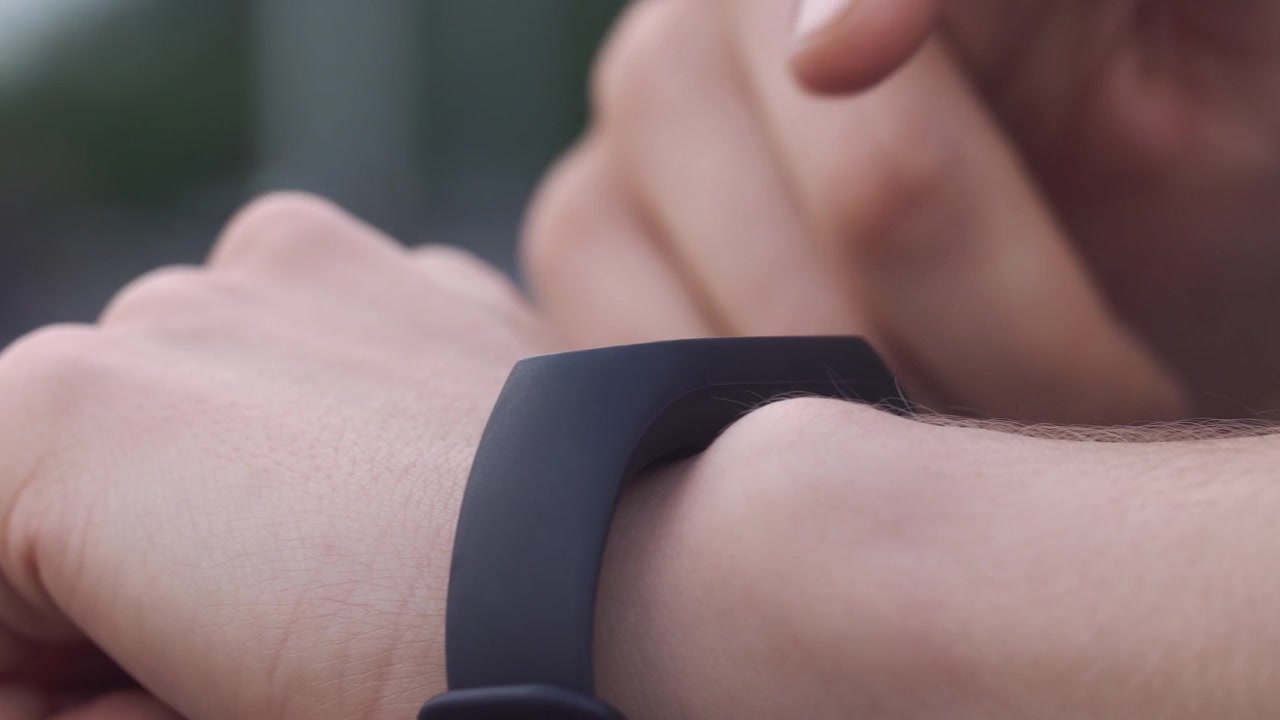 Close-up of Hand Interacting with Smartwatch Display