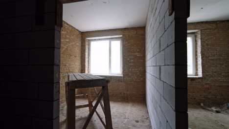 new walls of white bricks are added in the old building. wooden scaffolding in the rooms of the premise.