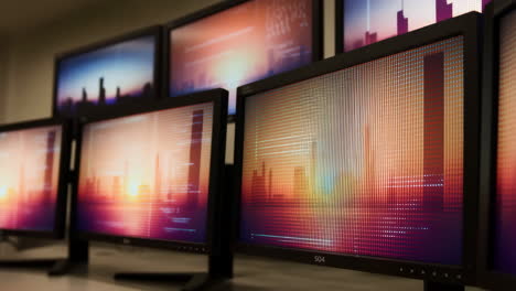 multiple computer monitors displaying abstract data and cityscapes