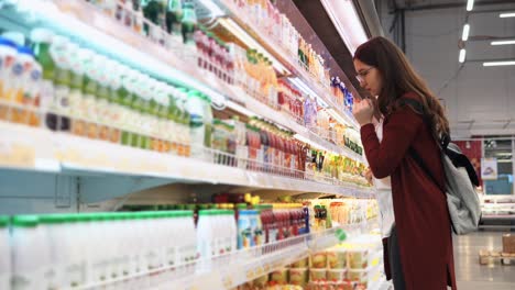 woman shopping for drinks at a supermarket