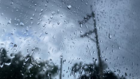 view from behind a rain-soaked glass on a gloomy, dark day