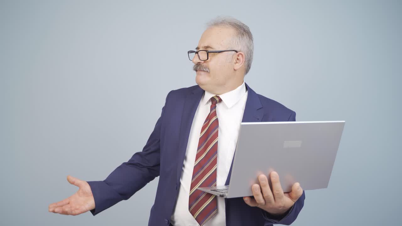 un hombre de negocios enojado cierra su computadora portátil enojado.