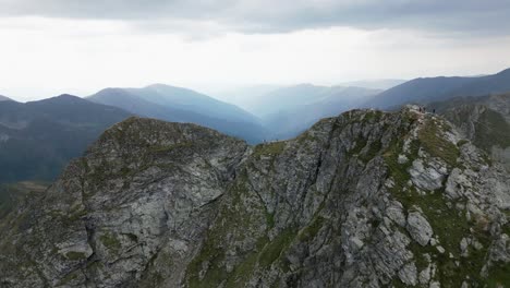 drone flies over a mountain peak with mountains, a sea and beautiful landscape in the background, carpathians, romania, europe, drone, summer