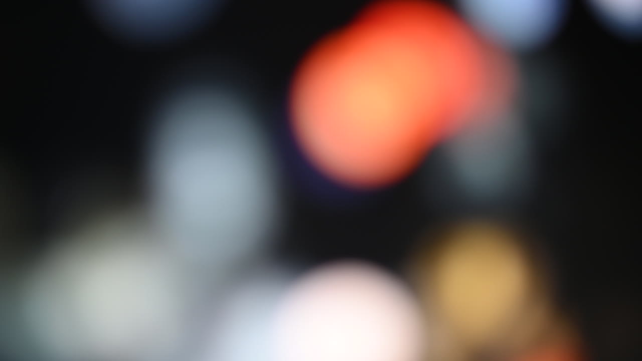 Abstract bokeh background with red, white, and yellow lights