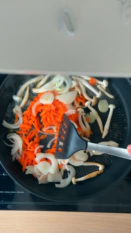 stir-frying vegetables in a pan