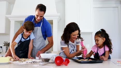 happy family preparing cookies in kitchen