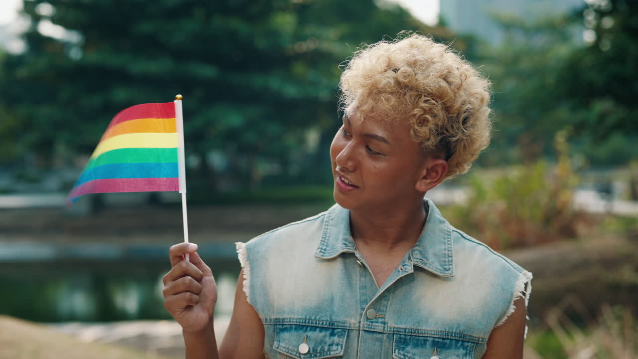 Young Person Holding Rainbow Flag