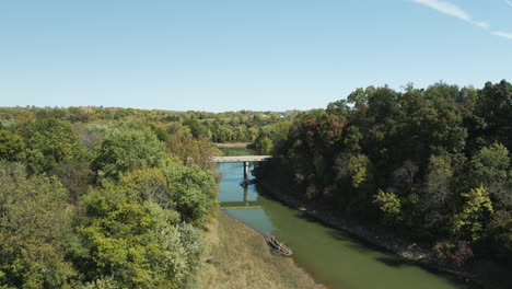 river with a small bridge near twin bridges park in arkansas, united states