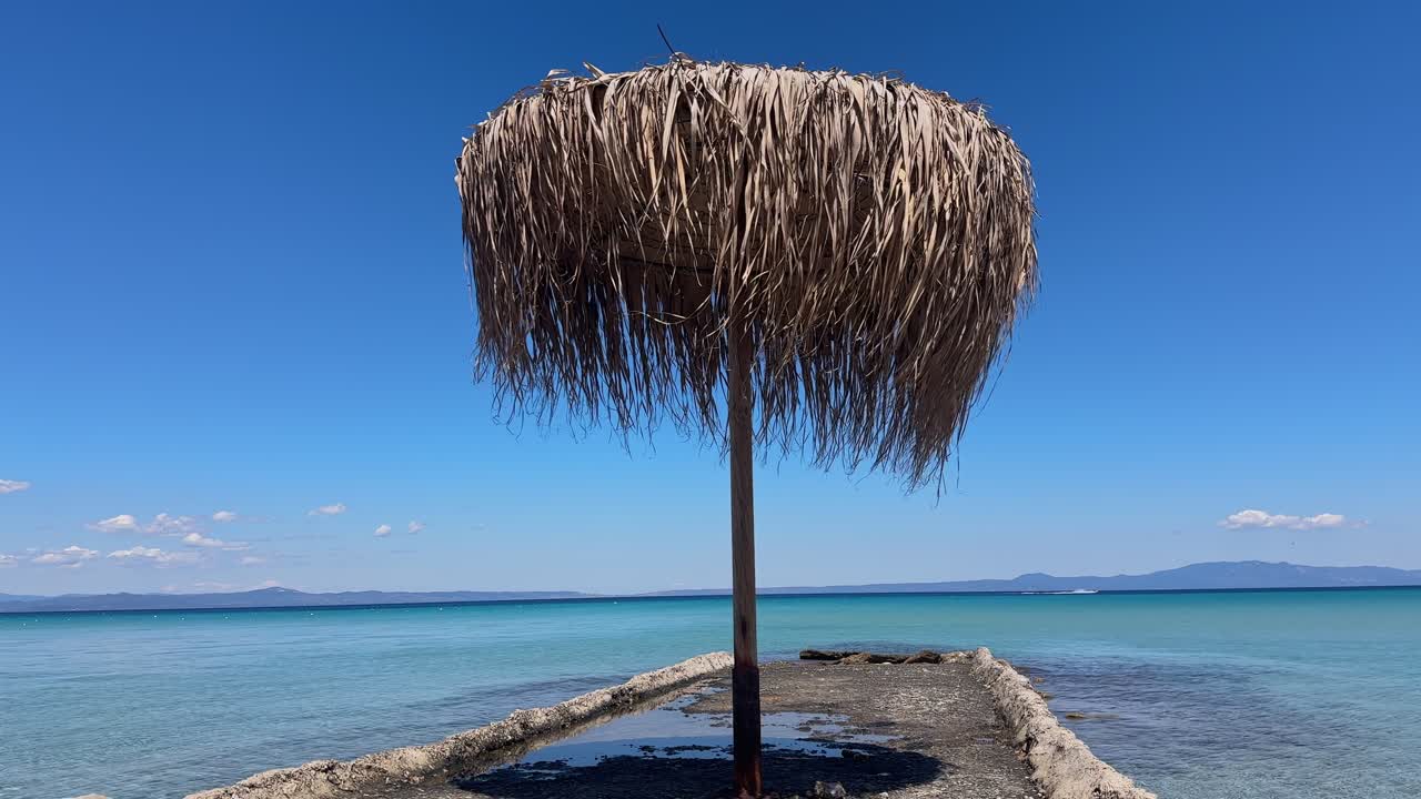 Stunning beach scene in Halkidiki, Greece, with elegant sunbeds facing the crystal-clear turquoise sea. A perfect summer escape in the heart of the Aegean.