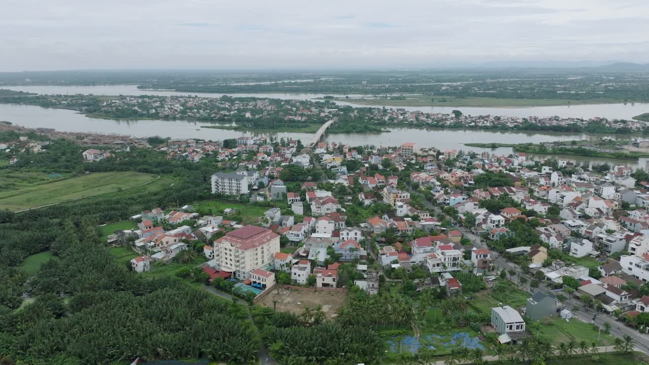 Hoi an, vietnam, showcasing houses, lush greenery, and river, aerial view