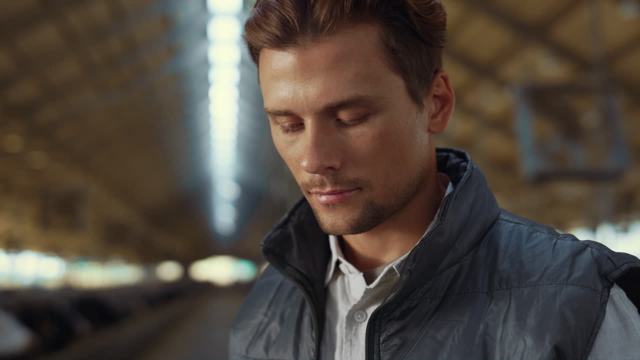 retrato de un hermoso granjero posando dentro de un cobertizo de animales.