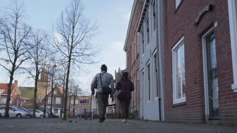 quaint dutch town, traditional homes, people exercise, community street
