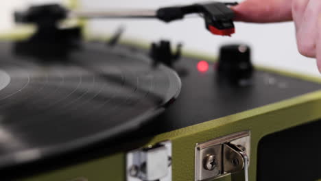 a medium shot of a record being played on a turn table and the arm places on the spinning record