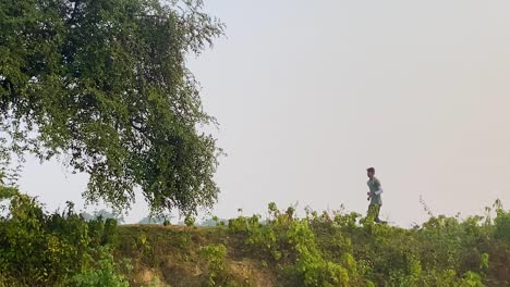 Tracking-shot-of-jogger-enjoying-run-outdoor-countryside-scenery,-slow-motion