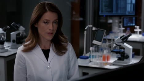 a woman in a lab coat in a laboratory setting
