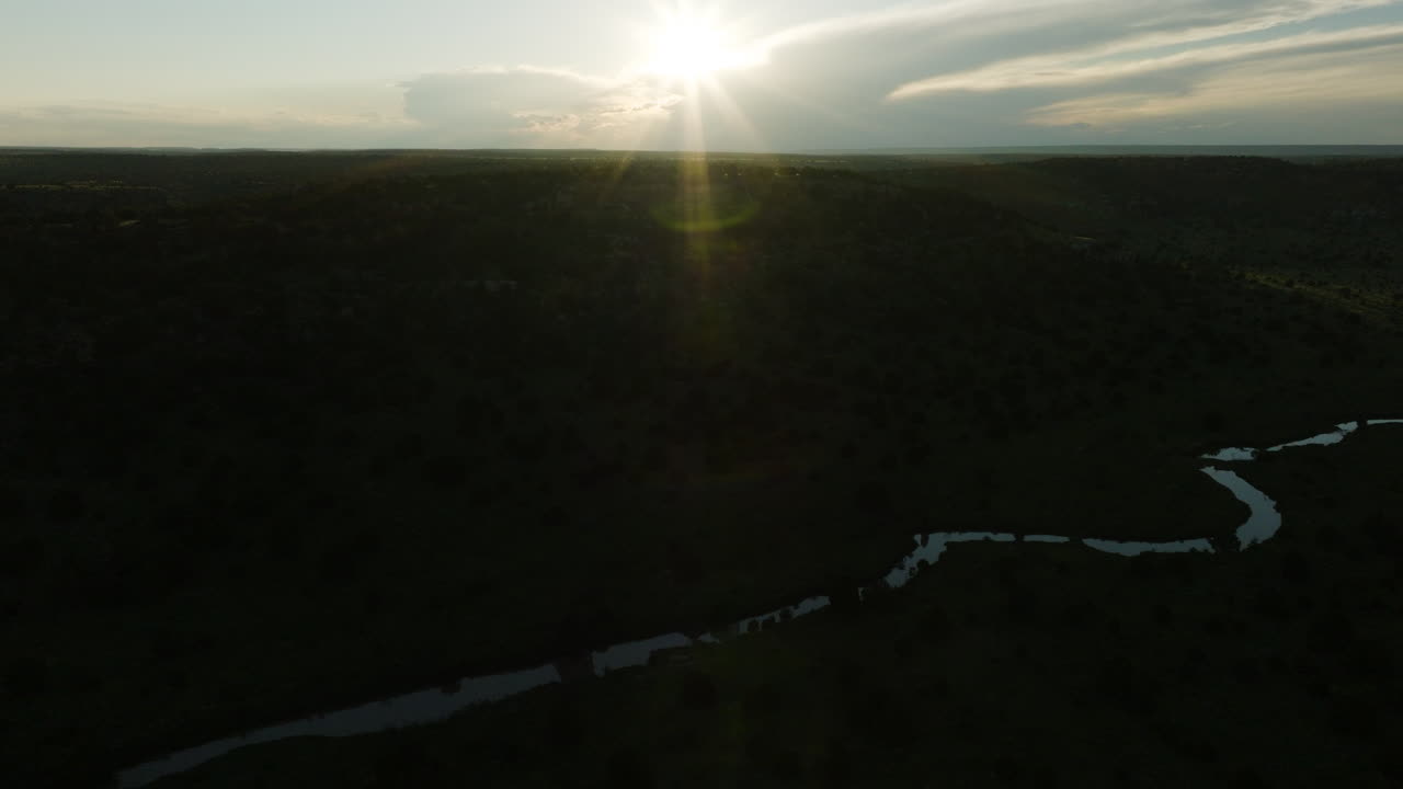 Sunset over a Winding River in a Forest