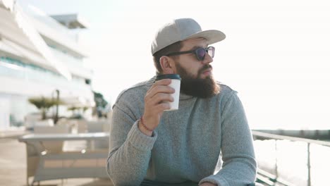 man drinking coffee on a cruise ship