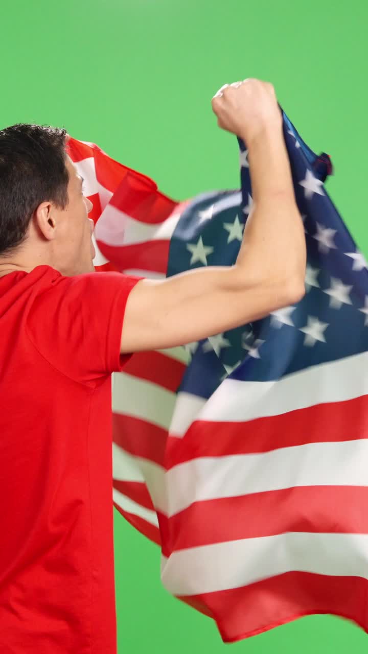 Man with his back turned waving american flag