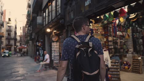 tourist in barcelona city center, walking by souvenir shop