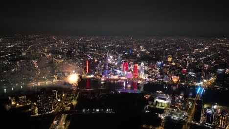nighttime view of ho chi minh city’s skyline with fireworks, featuring the bitexco tower
