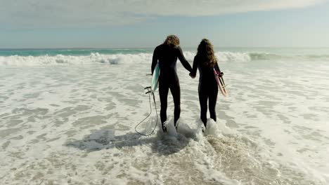 couple walking toward the sea 4k