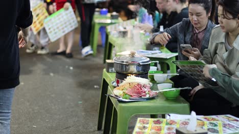 customers enjoying street food at a bustling night market