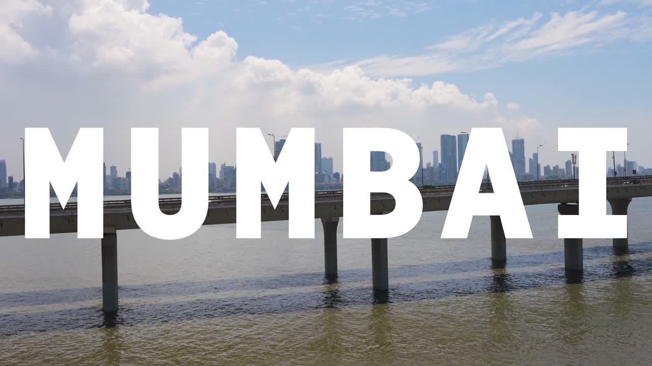 tomada de avión no tripulado del horizonte de la ciudad de mumbai con el puente de enlace marítimo de bandra worli superpuesto con gráficos animados que deletrean mumbai