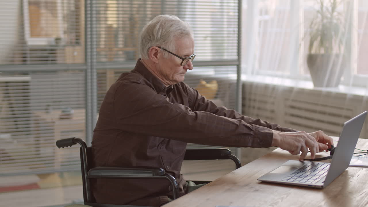 Senior Man in Wheelchair Working in Call Center